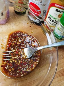 mix together garlic, ginger, red pepper, white pepper, brown sugar, tamari sauce, fish sauce, rice vinegar and arrowroot flour