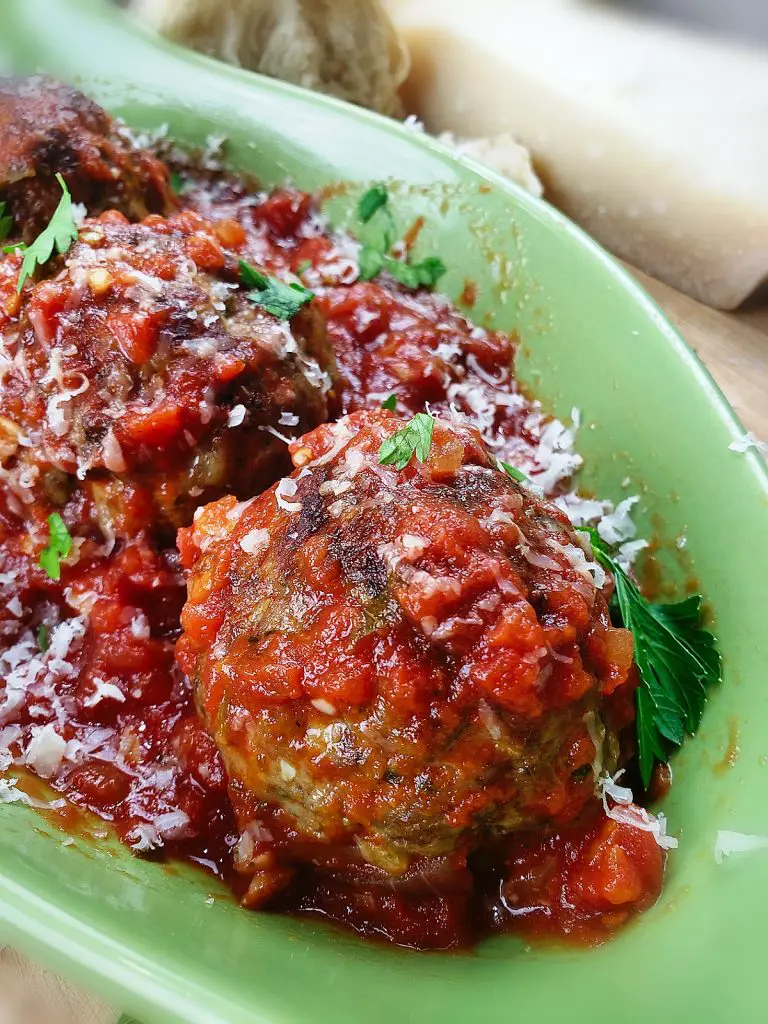 meat balls sprinkeld with parmesan cheese and fresh parsley