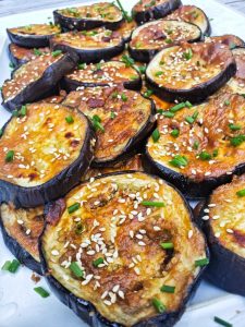 roasted eggplant glazed with miso sauce sprinkled with sesame seeds and fresh chives