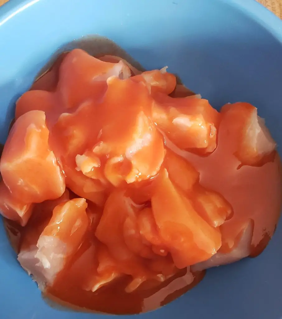diced raw chicken tenders in franks red hot sauce