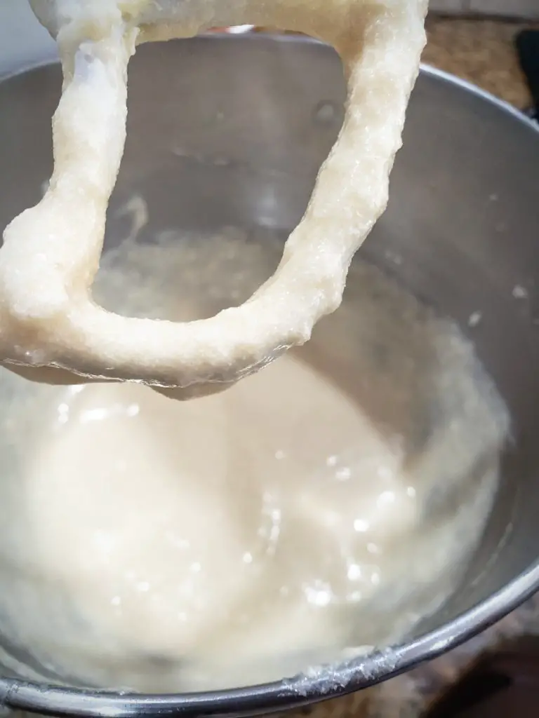 wet ingredients of cake batter in electric mixer making vanilla cupcakes