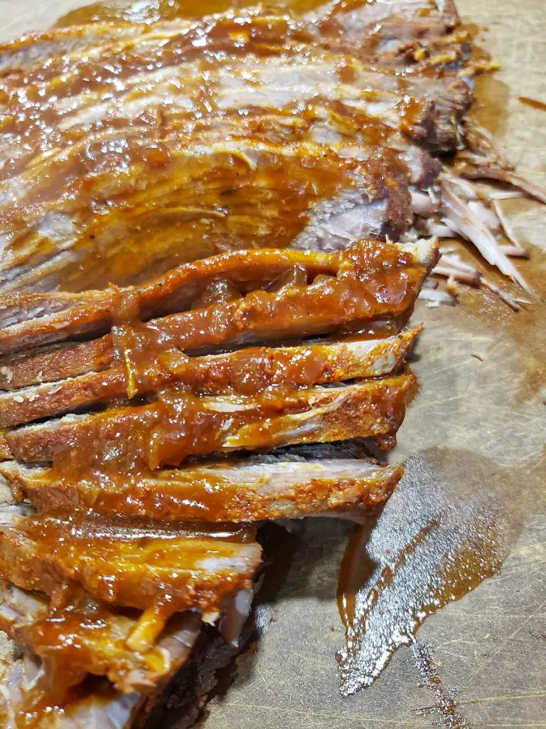 sliced brisket against the grain and spoon sauce over