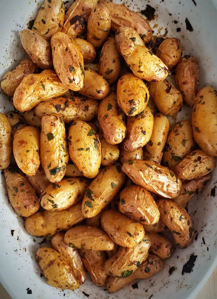 roasted golden brown fingerling potatoes with herbs and spices