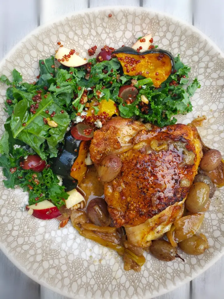 cast iron seared and roasted chicken thigh served with kale salad
