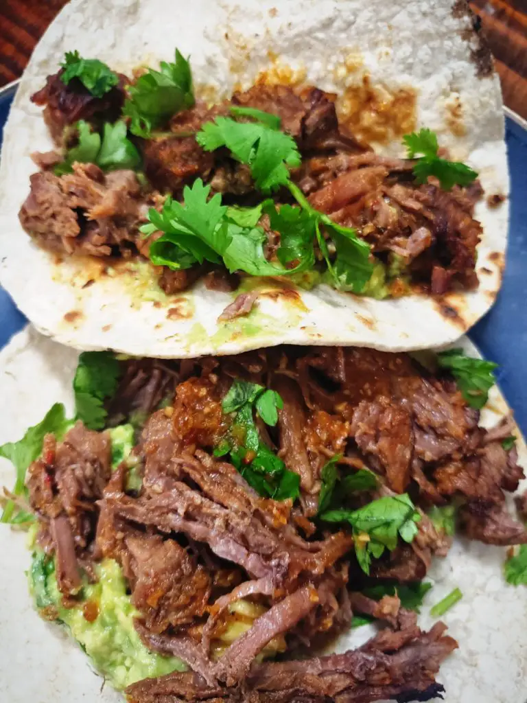 two shredded barbacoa beef tacos