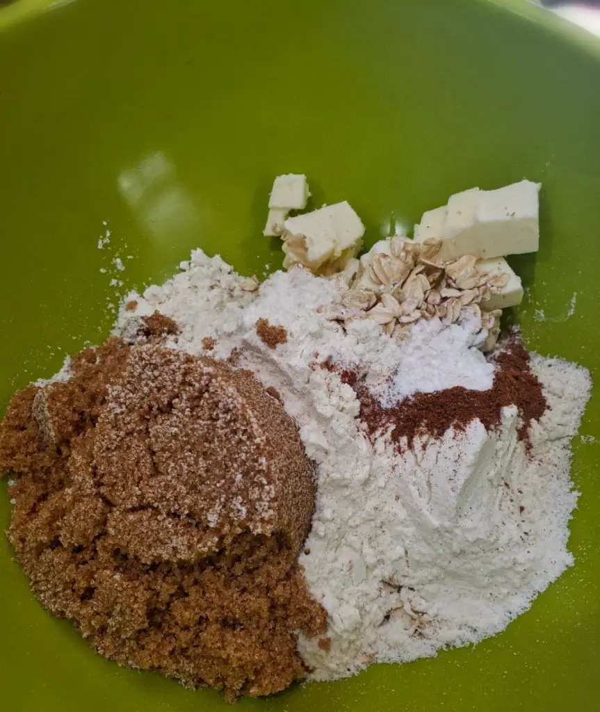 combine brown sugar, flour, cubed butter, oats, cinnamon, baking powder, and salt to make apple crisp topping