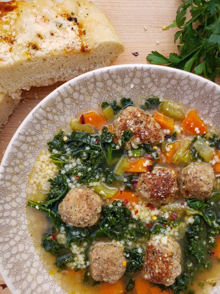 italian wedding soup with focaccia bread and parsley