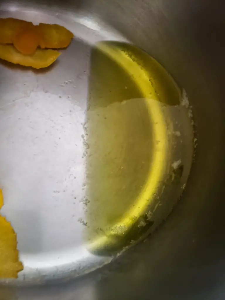boiled orange peel leaves water orange colored to make CRANBERRY SAUCE WITH APPLES AND ORANGE ZEST