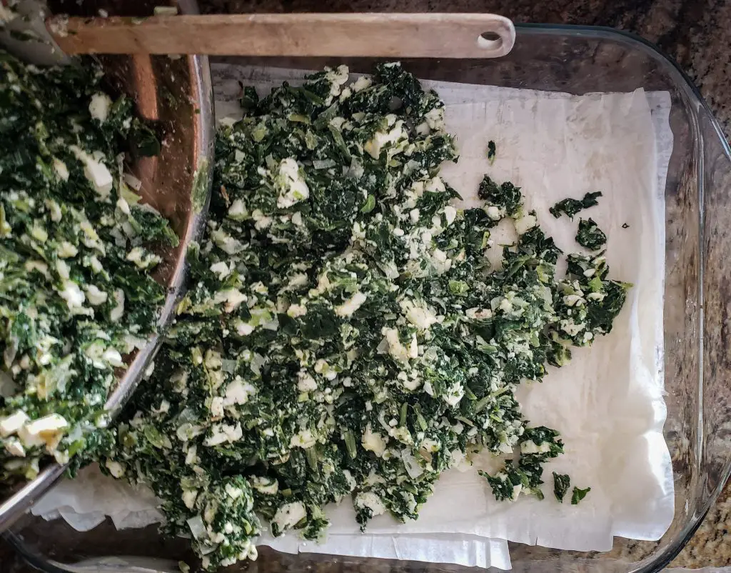 pour spinach feta filling over base layers of phyllo dough