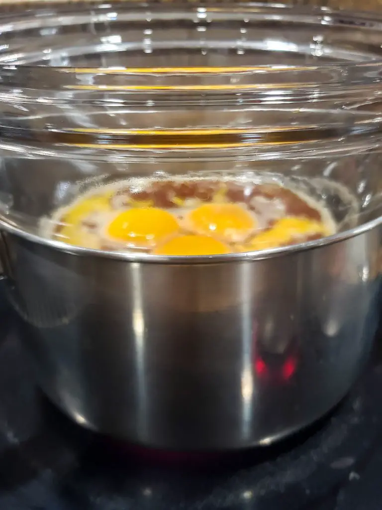 heat egg yolks, espresso and sugar in double boiler to make dark chocolate mousse