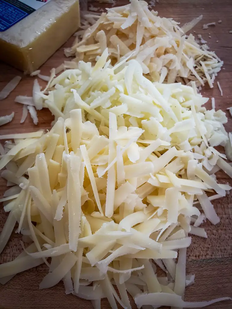 image of three types of shredded cheese on cutting board