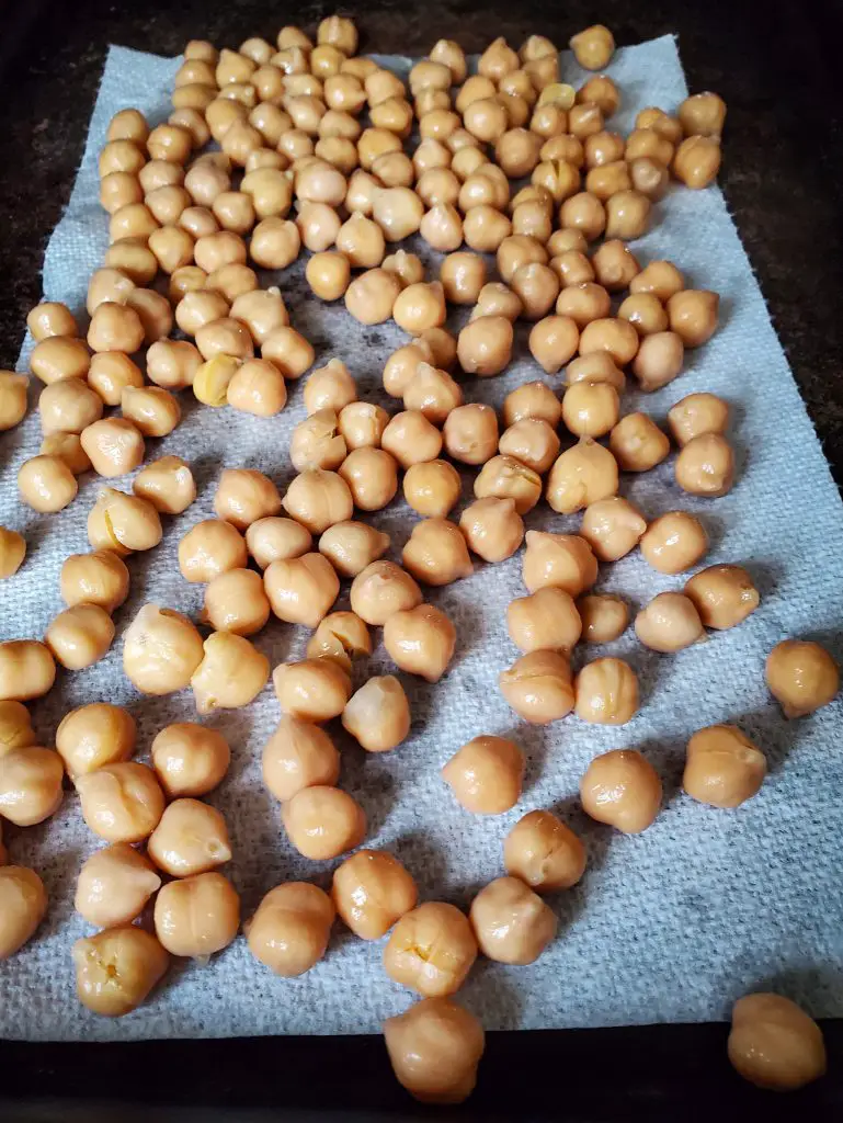 image of chick peas drying on paper towel lined baking sheet