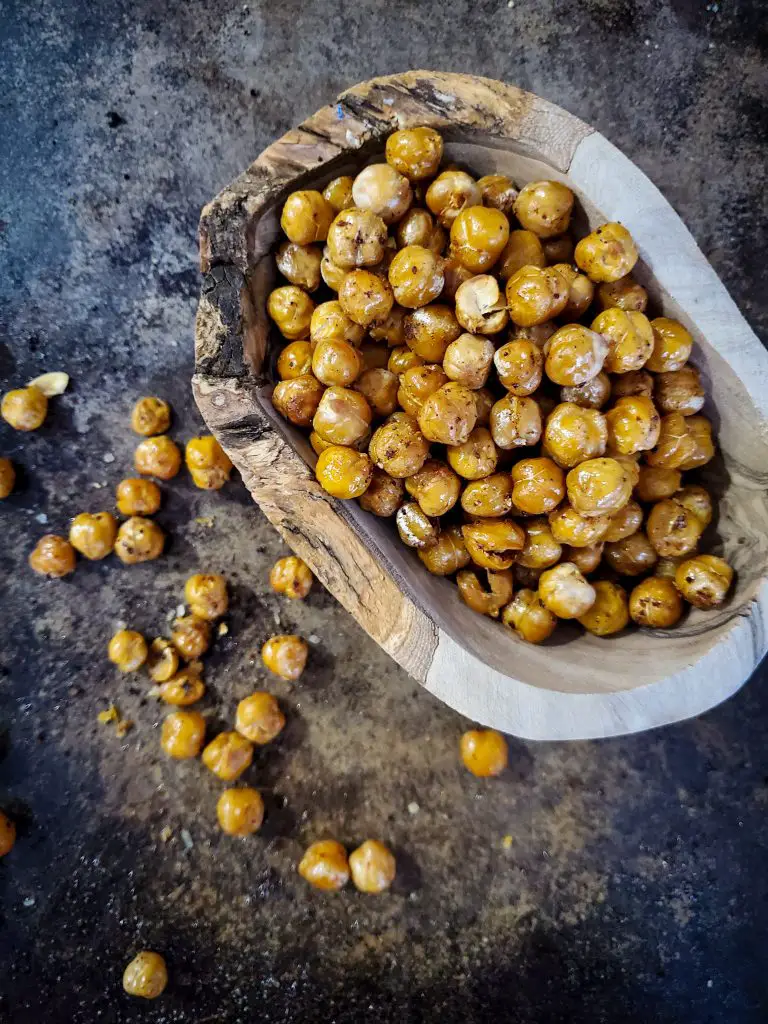 overhead image of wooden bowl of crispy roasted chick peas