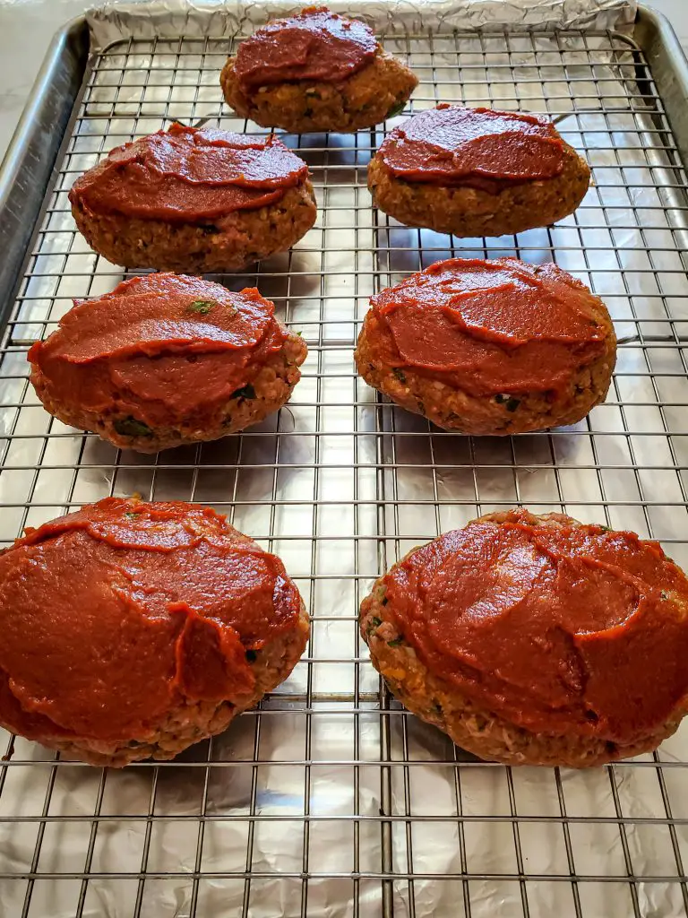 image of individual mini meatloaf on baking sheet