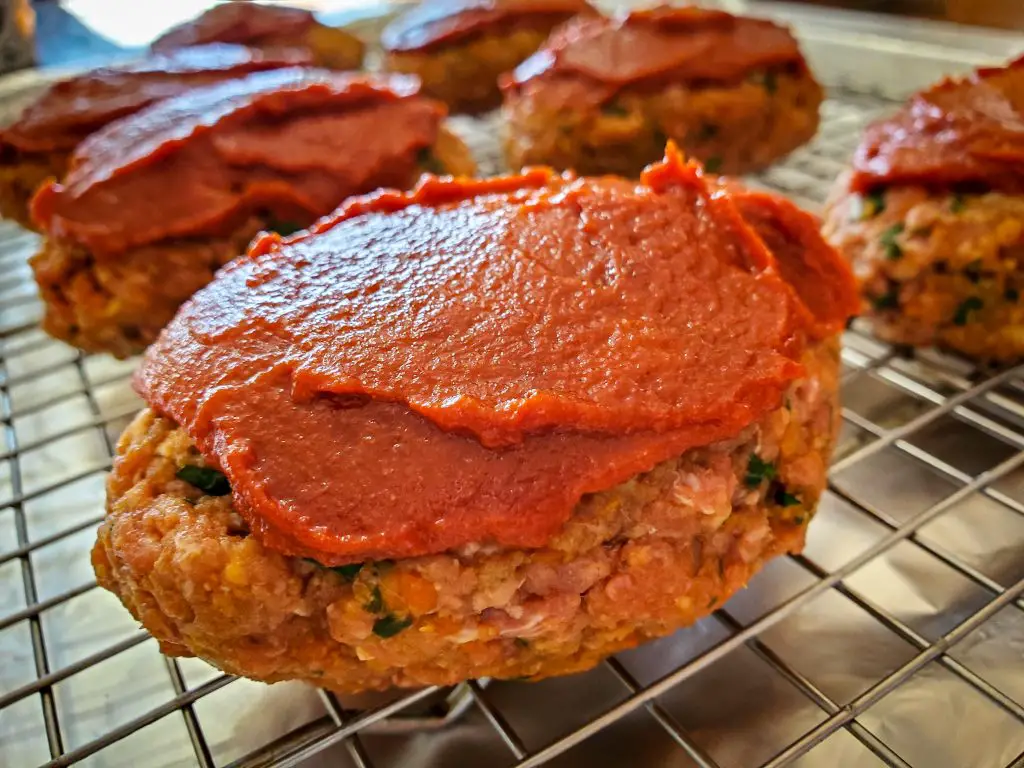 image of individual mini meatloaf on baking sheet