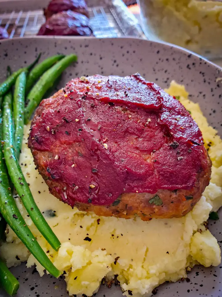 image of mini meatloaf with tomato glaze served with mashed potatoes and green beans
