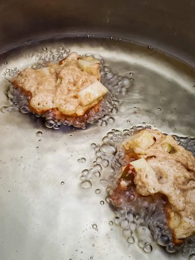 upclose image of CHAI-SPICED APPLE FRITTERS frying in oil