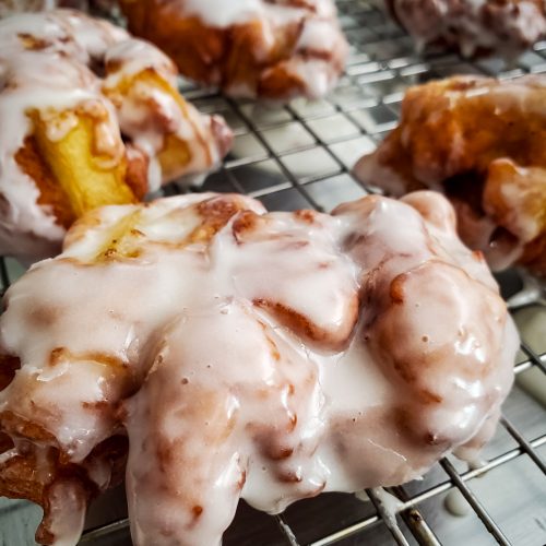 close up side angle of frosted chai spiced apple fritter
