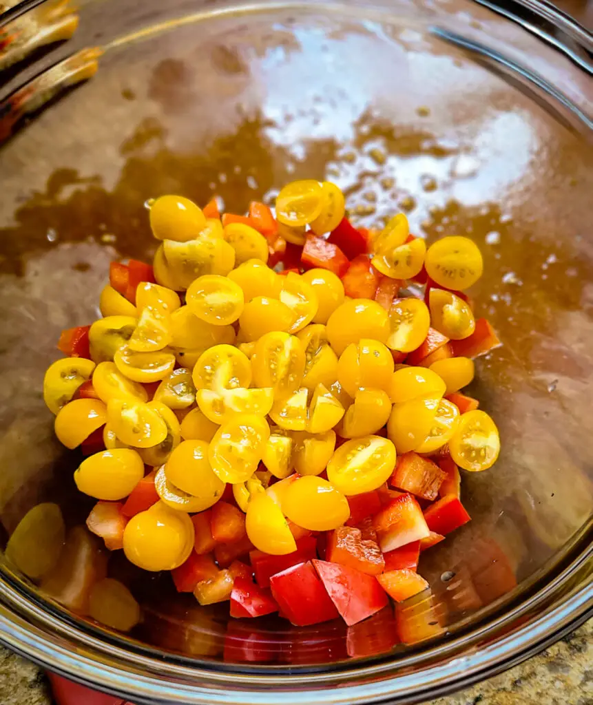 salad bowl with chopped red pepper and quartered cherry tomatoes