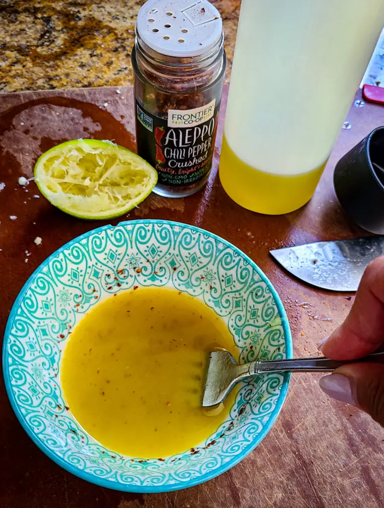 olive oil, lime juce, salt and aleppo pepper flakes make a simple dressing for salad