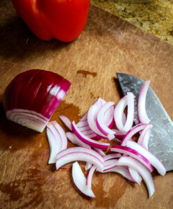 sliced red onion on cutting board