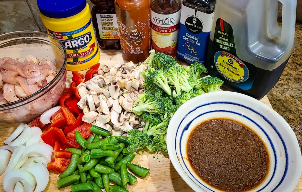 image with shows the ingredients needed to make chicken and vegetable stir fry.