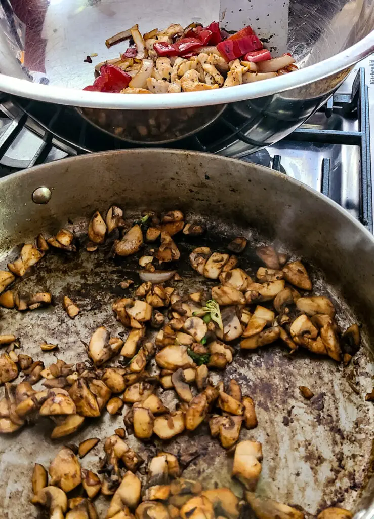 Image of chopped mushrooms browned in skillet for the purpose of making chicken and vegetable stir fry