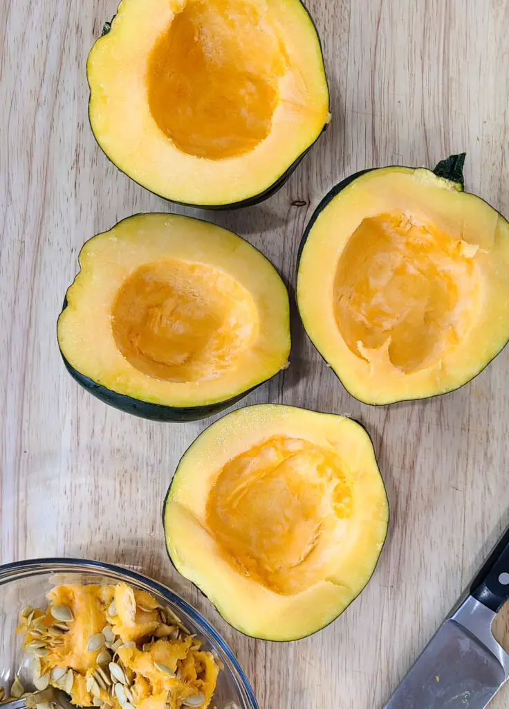 how to roast acorn squash, cut squash in half and remove seeds