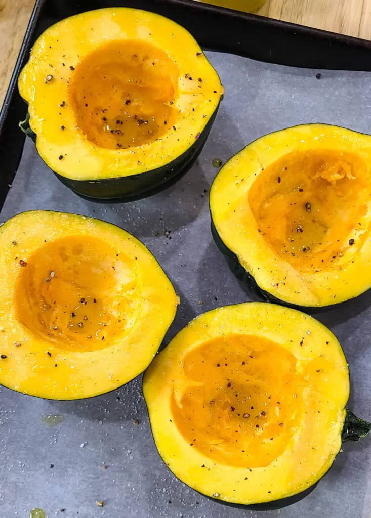 how to roast acorn squash, drizzle inside of squash with olive oil, salt and pepper