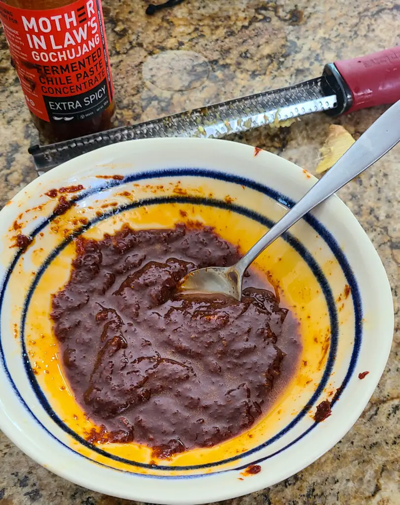 bowl of gochujang rub to put on chicken to make slow roasted gochujang chicken