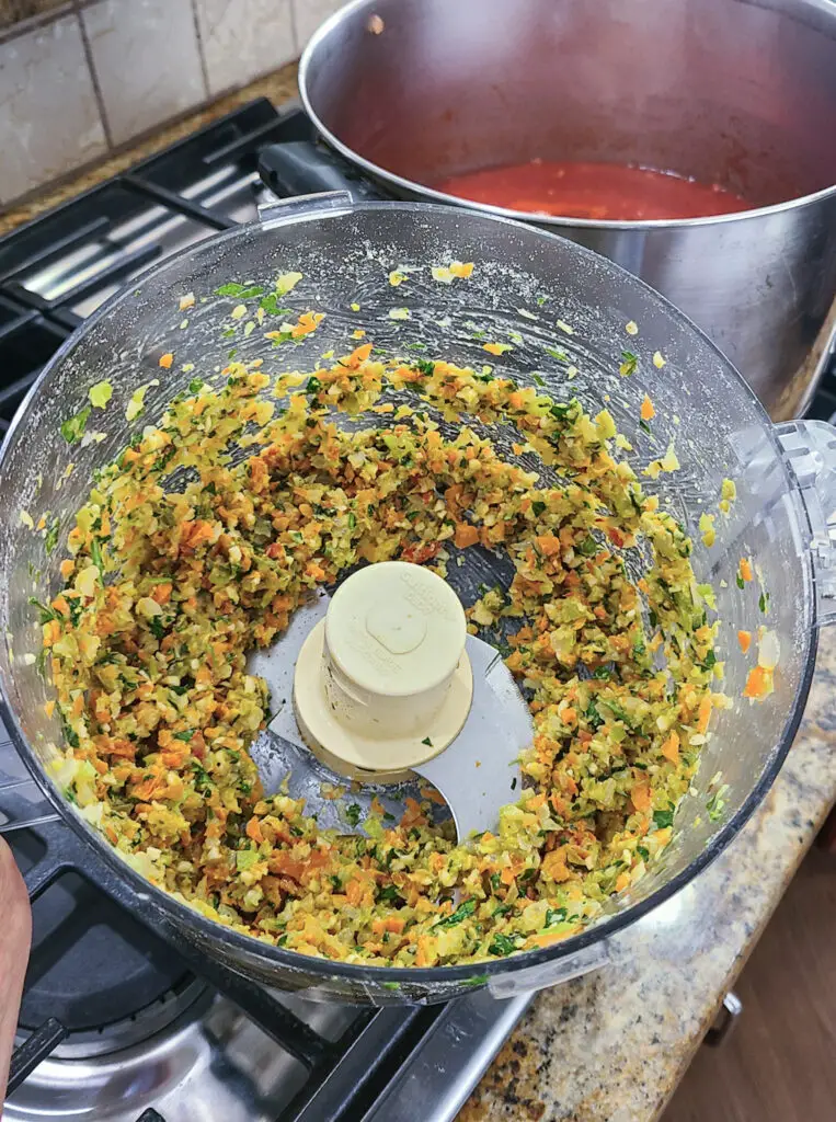 Image of pulsed ingredients in a food processor for purpose of showing steps of how to make Italian style meatloaf