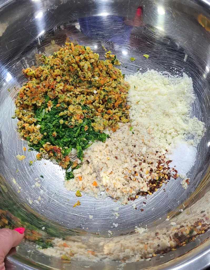 Image of ingredients in a mixing bowl for the purpose of showing steps of how to make Italian style meatloaf