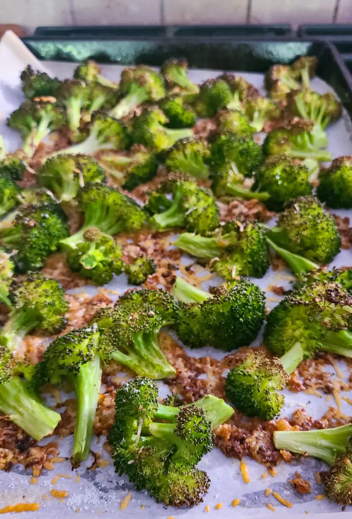 image of roasted crispy parmesan roasted broccoli on baking sheet