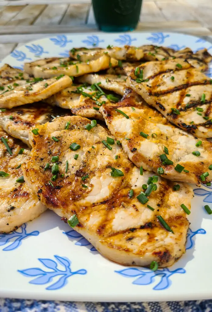 ginger beer and mustard grilled pork chops on blue serving platter