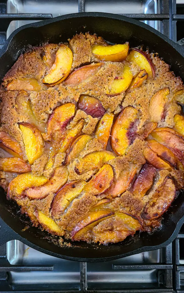 baked peach cobbler in cast iron skillet