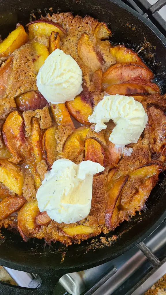 baked skillet peach cobbler with vanilla ice cream