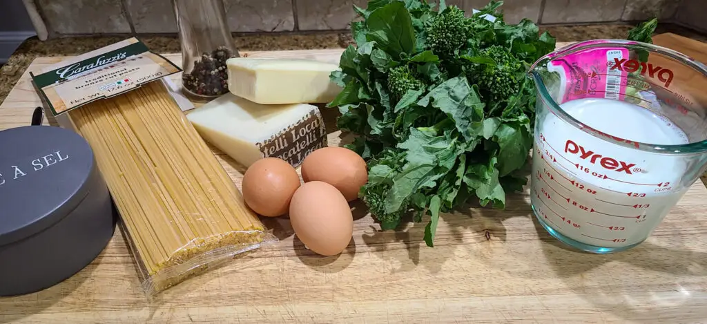 image displaying ingredients: Spaghetti, broccoli rabe, cheese, eggs, milk, salt, pepper.