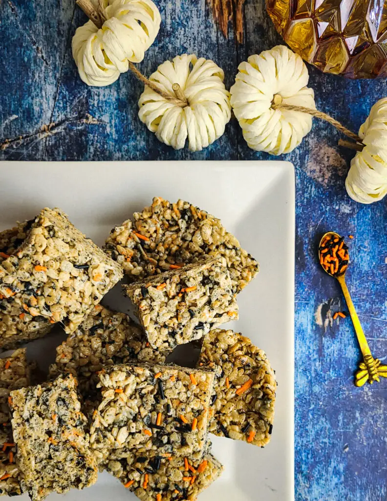 platter of halloween dessert idea of toasted marshmallow rice krispie treats with festive orange and black spinkles